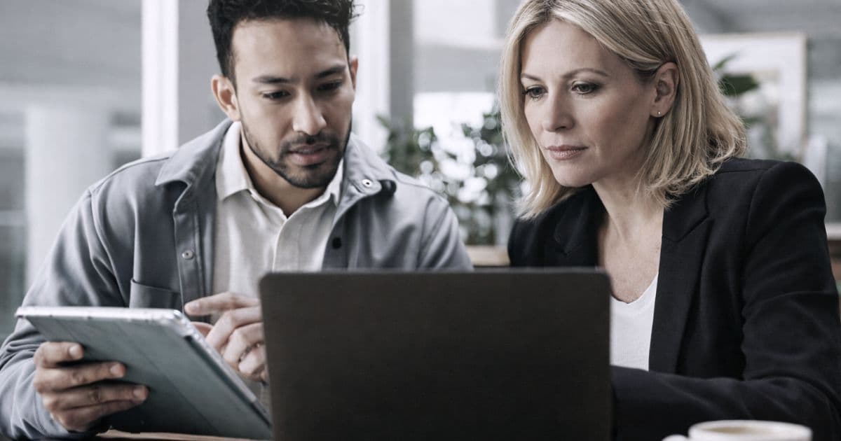 SaaS founder reviewing competitor tracking tools on desktop dashboard with competitor names on notepad